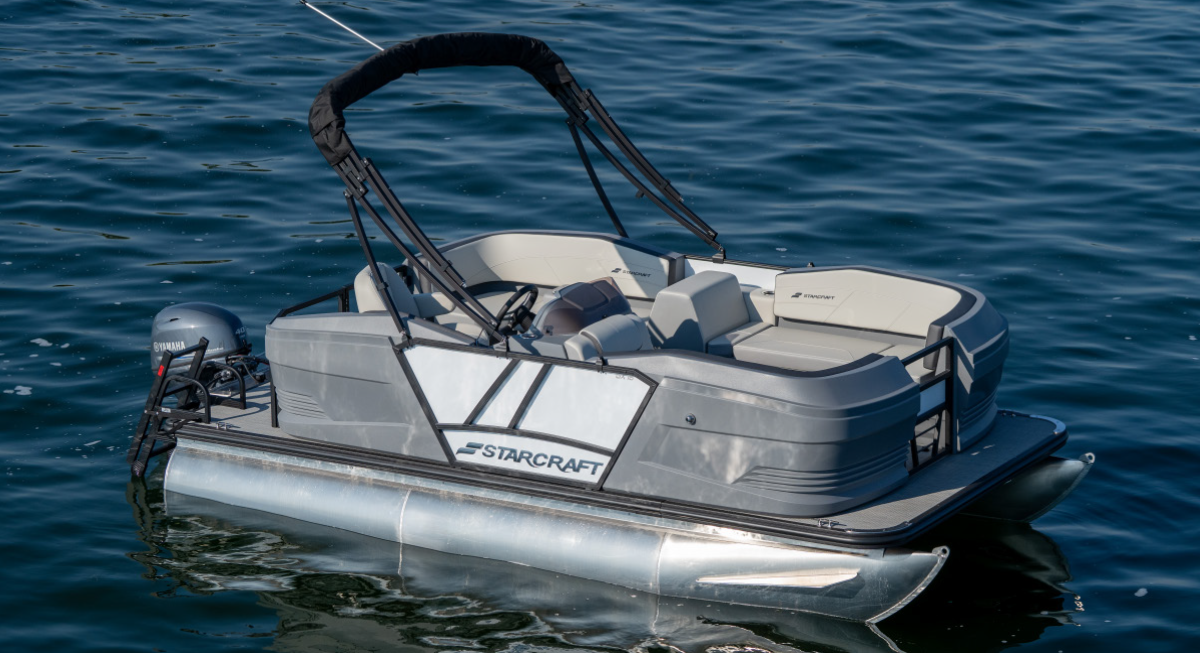 Starcraft GX 16 R pontoon motorboat vehicle stationary out on the water with no people inside at all