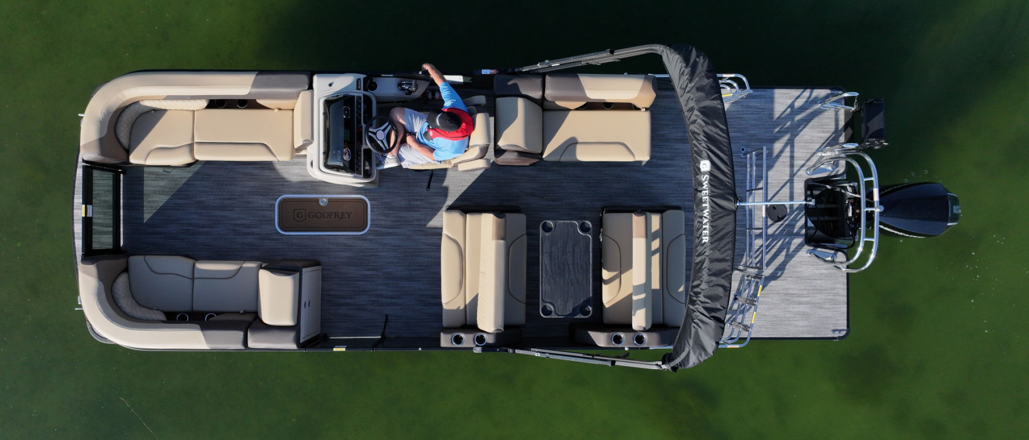 top view of Godfrey Sweetwater 2286DT with man in driver's seat