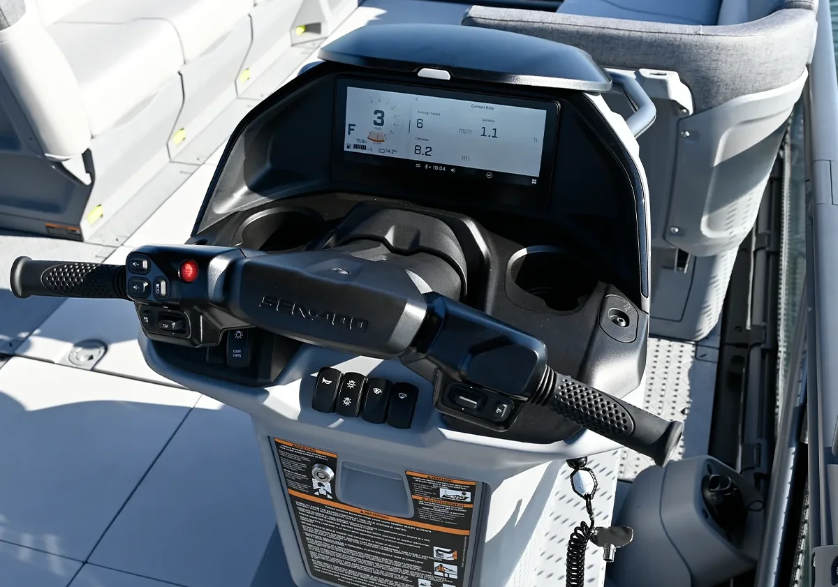 Close-up of the digital dashboard and handlebar steering system on a modern Sea-Doo Switch pontoon.