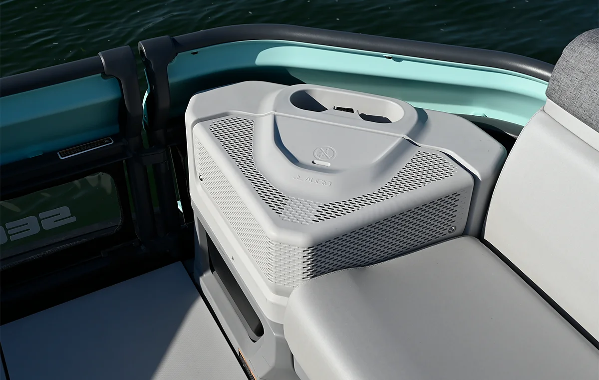 Close-up of a high-performance JL Audio speaker mounted on a Sea-Doo boat, featuring a sleek, modern design and integrated cup holders.