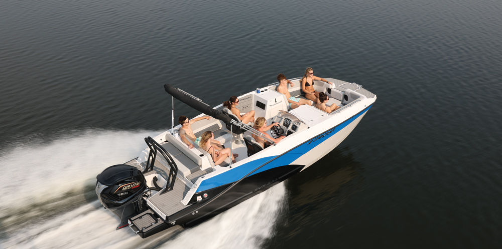 Overhead view of a Starcraft SVX 231 deck boat with a blue and black hull. Seven passengers occupy the various seating zones while traveling at high speed.