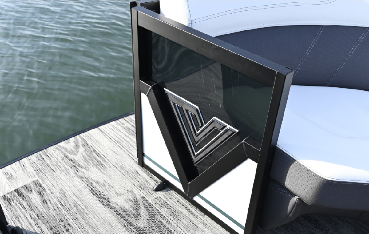 Close-up of a boat's side gate featuring a black-and-white geometric design with a silver "V" logo.