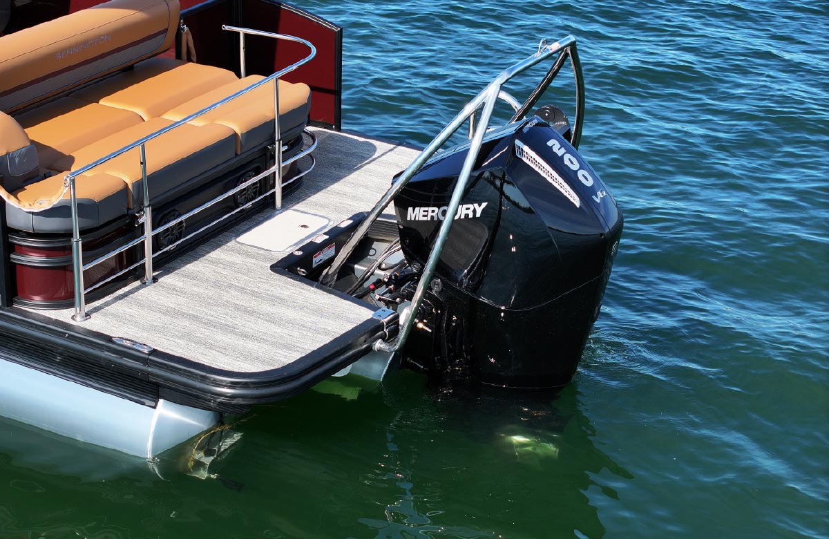 Rear deck of a boat featuring a large black 200 hp Mercury outboard engine and a silver safety tow bar.