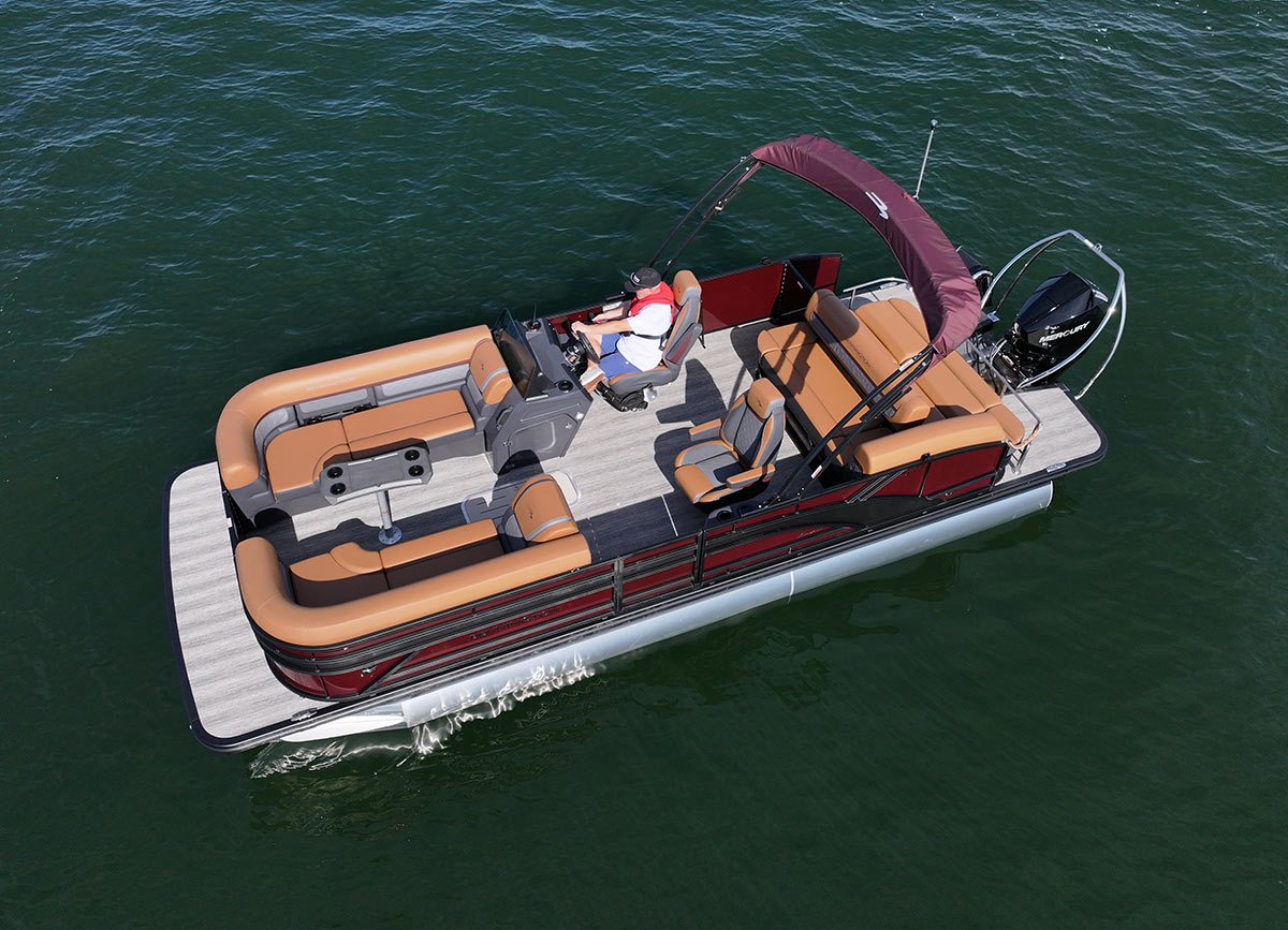 Overhead aerial shot of the entire deck layout of a Bennington pontoon boat on the water, highlighting the seating arrangement.