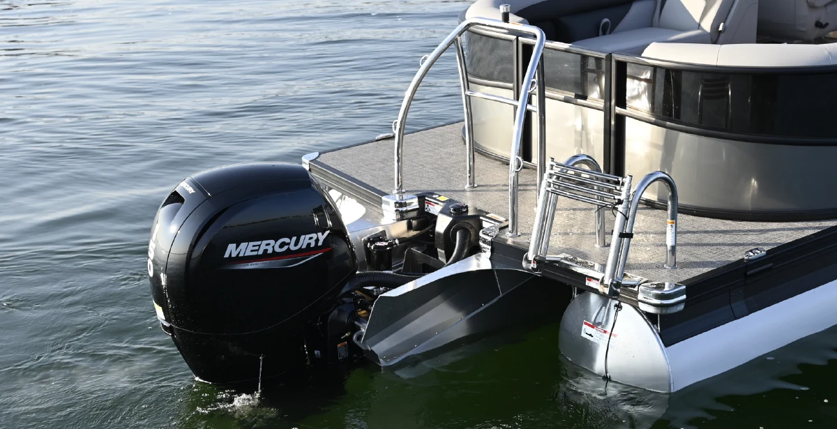 Rear view of a Barletta Aria pontoon boat featuring a 150-horsepower Mercury FourStroke outboard engine, a stainless steel ski tow bar, and an integrated swim ladder.