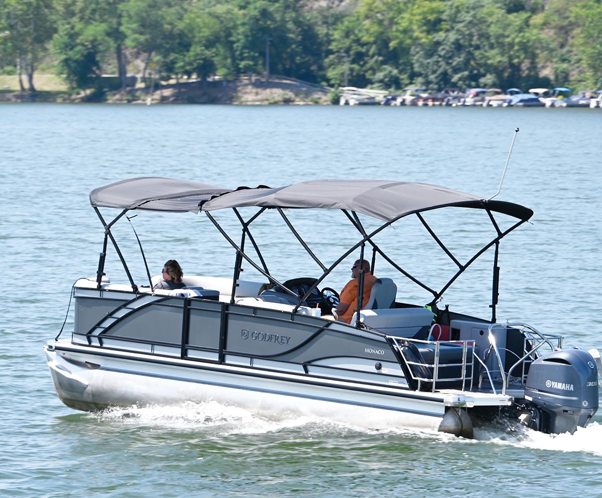 Al Razzis and Laura Goodman-Jenkins driving off in pontoon