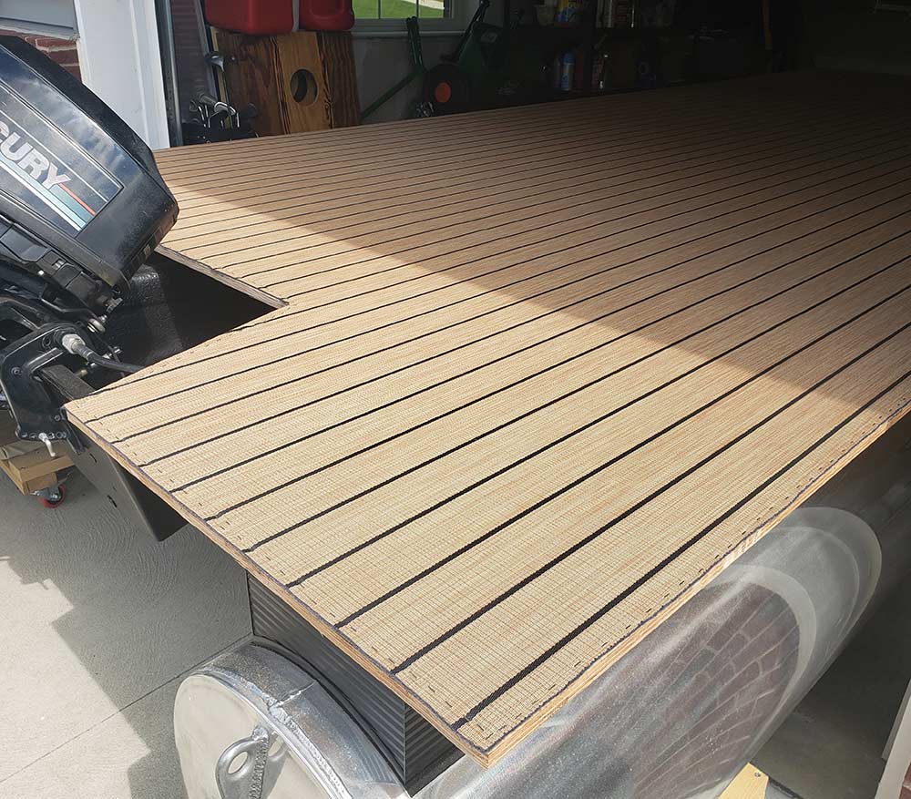 Newly installed faux-teak flooring on a pontoon boat deck.