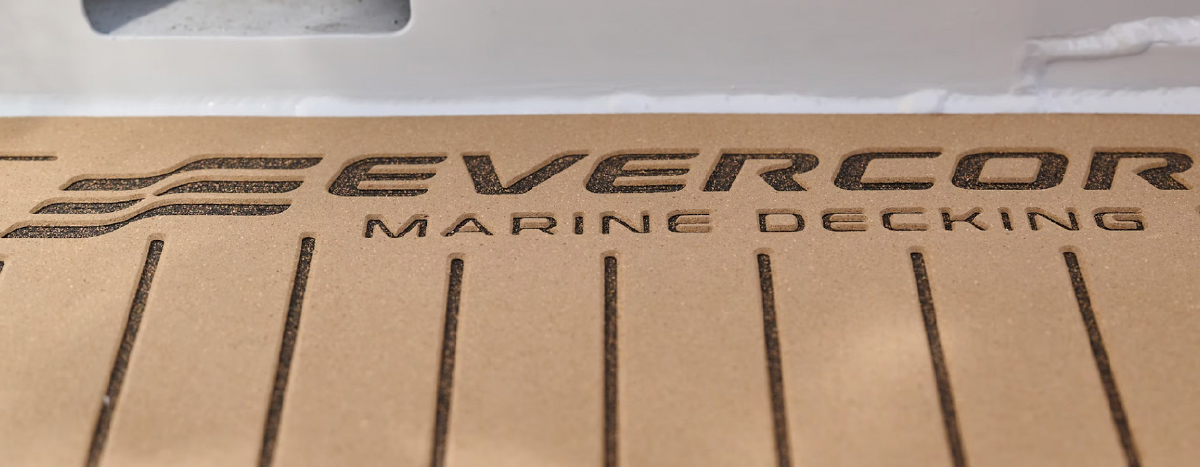 Close-up of Evercore Marine Decking textured tan boat flooring with debossed lettering and groove lines.