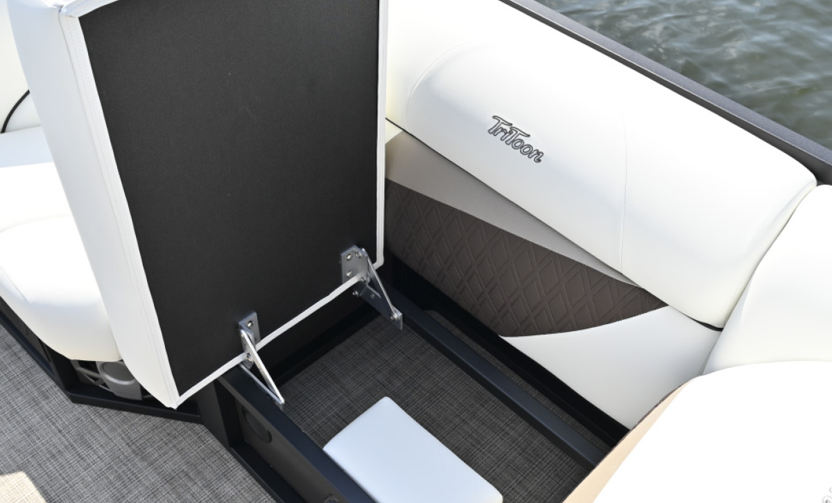 Open hinged bench seat revealing under-seat storage space inside a TriToon pontoon boat.
